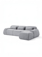 Sofa modulaire gris TOCO Meubles Mia avec trois sections et ottoman assorti au design contemporain et confortable