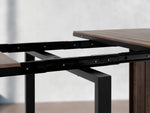 Table à manger extérieure extensible Transformer en noyer foncé, cadre noir – gros plan sur le bois massif, mécanisme coulissant – Meubles TOCO