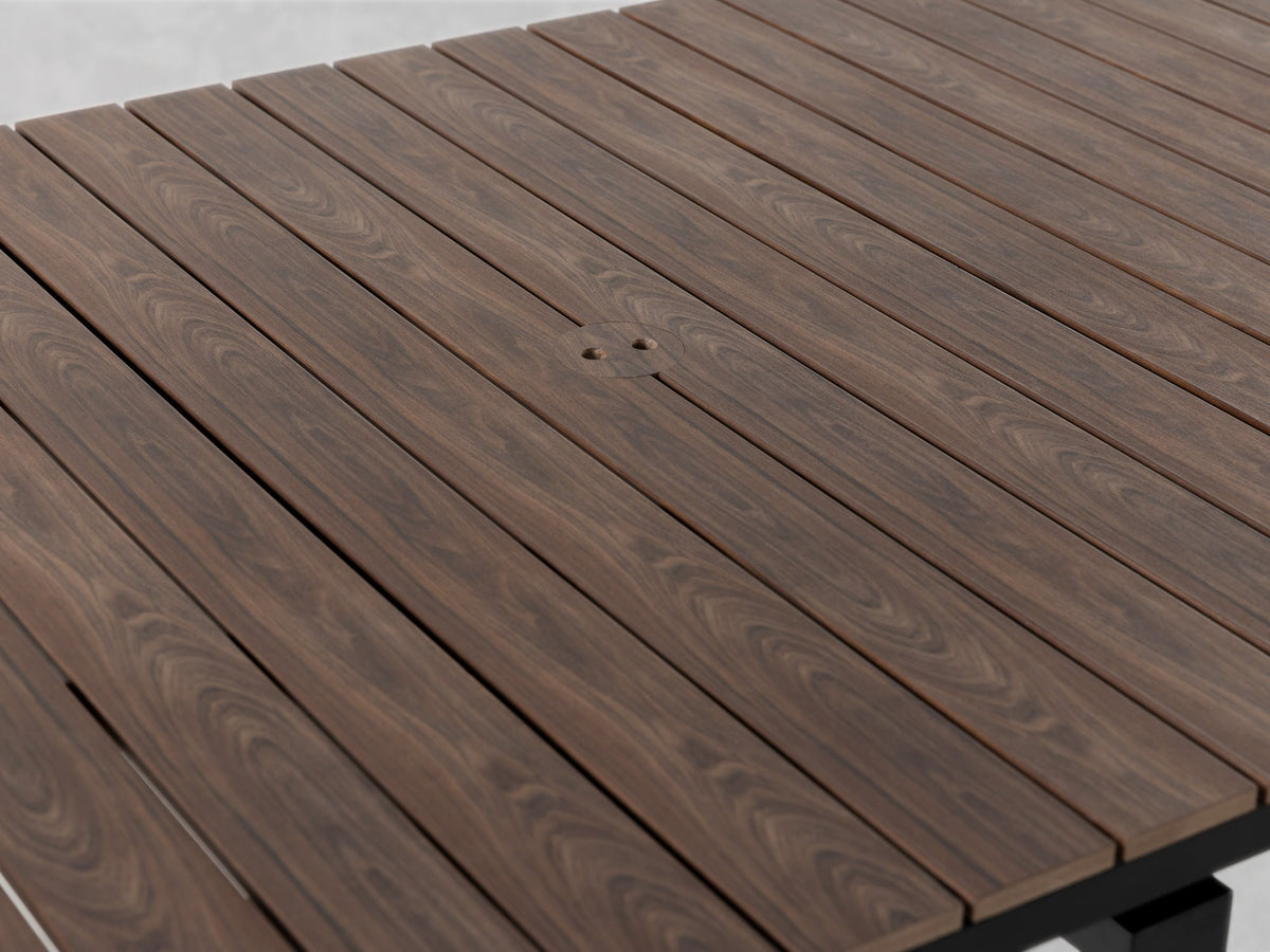 Table à manger extérieure extensible Transformer en noyer foncé, cadre noir – gros plan sur le bois massif, fermée, format compact – Meubles TOCO