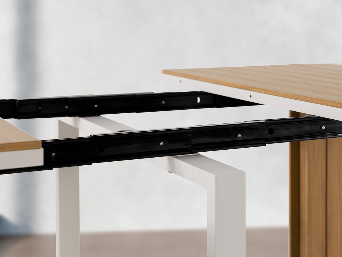 Table à manger extérieure extensible Transformer en chêne clair, cadre blanc – gros plan sur le bois massif, mécanisme coulissant – Meubles TOCO