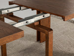 Table à manger extensible Transformer en noyer américain – gros plan sur le bois massif, mécanisme coulissant, mise en situation – Meubles TOCO