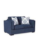 Causeuse TOCO Meubles Evan en tissu bleu marine avec deux coussins décoratifs à motifs géométriques blancs