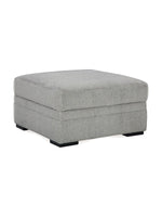 Ottoman Ugo TOCO Meubles carré en tissu texturé gris ciment avec pieds noirs, design moderne et élégant