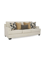 Canapé TOCO Meubles Moka couleur quartz avec coussins décoratifs géométriques et unis sur fond blanc