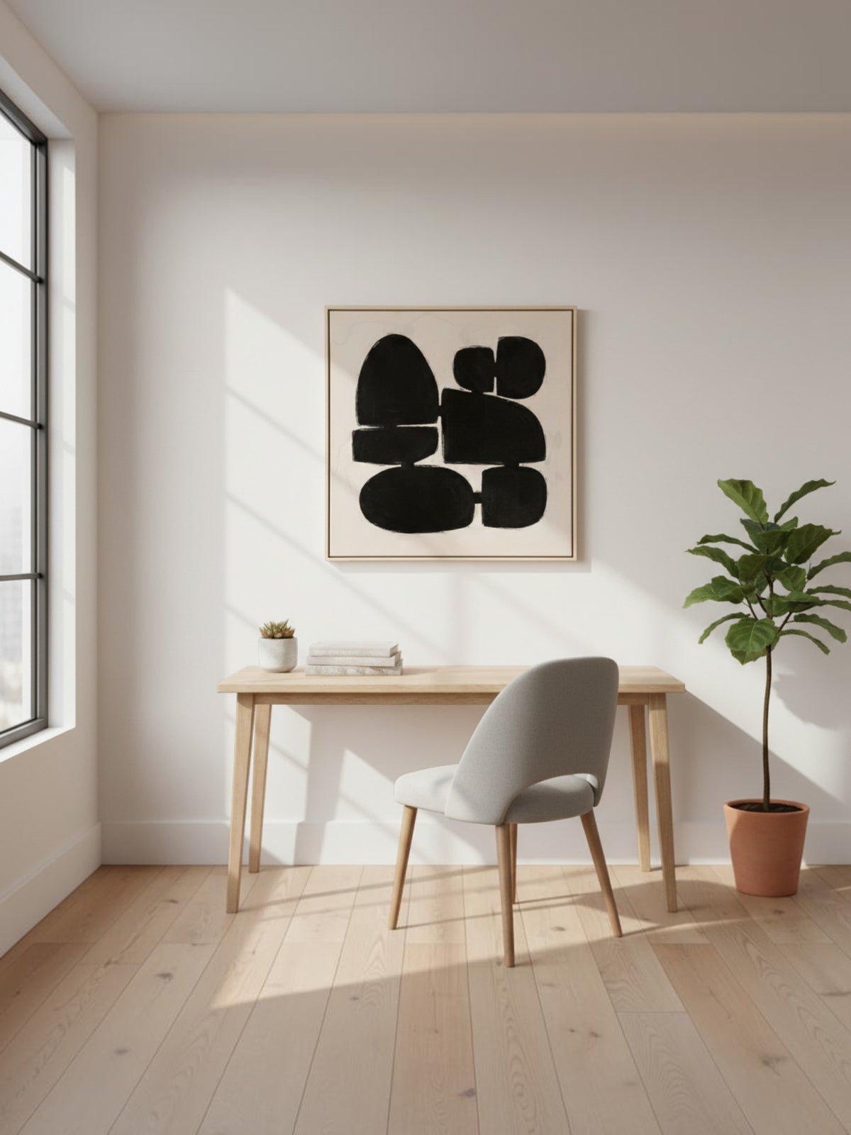 Cadre décoratif Pillars I de TOCO Meubles avec motif abstrait noir sur fond clair dans un bureau moderne et lumineux