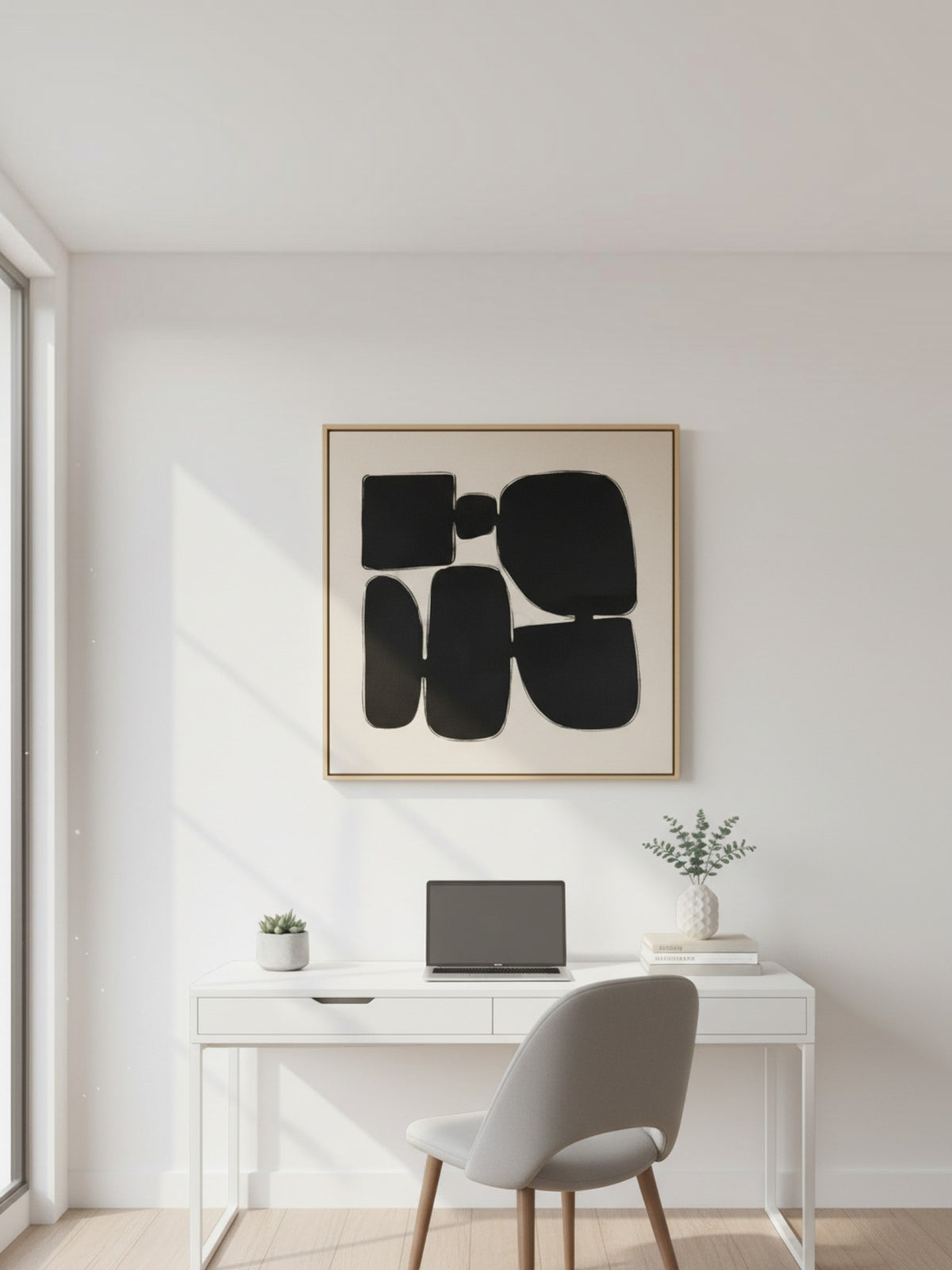 Cadre décoratif TOCO Meubles Pillars II avec art abstrait noir sur fond beige, suspendu au-dessus d'un bureau blanc.