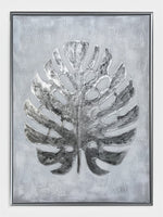 Cadre décoratif TOCO Meubles Paradise Palm II avec motif de feuille de palmier argentée sur fond gris texturé
