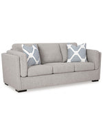 Canapé trois places TOCO Meubles Evan en tissu gris avec coussins décoratifs à motifs géométriques bleus et blancs