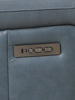 TOCO Meubles Sofa inclinable Miles bleu cuir avec commandes intégrées pour réglage électrique.