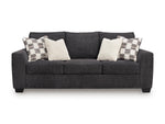 Canapé-lit Muna TOCO Meubles anthracite en tissu, avec 4 coussins décoratifs, design moderne et confortable.