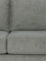 Gros plan sur le tissu texturé gris anthracite du canapé sectionnel Zela de TOCO Meubles