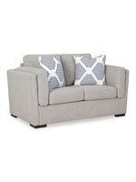 Causeuse Evan TOCO Meubles en tissu gris avec deux coussins décoratifs à motifs géométriques bleus et blancs