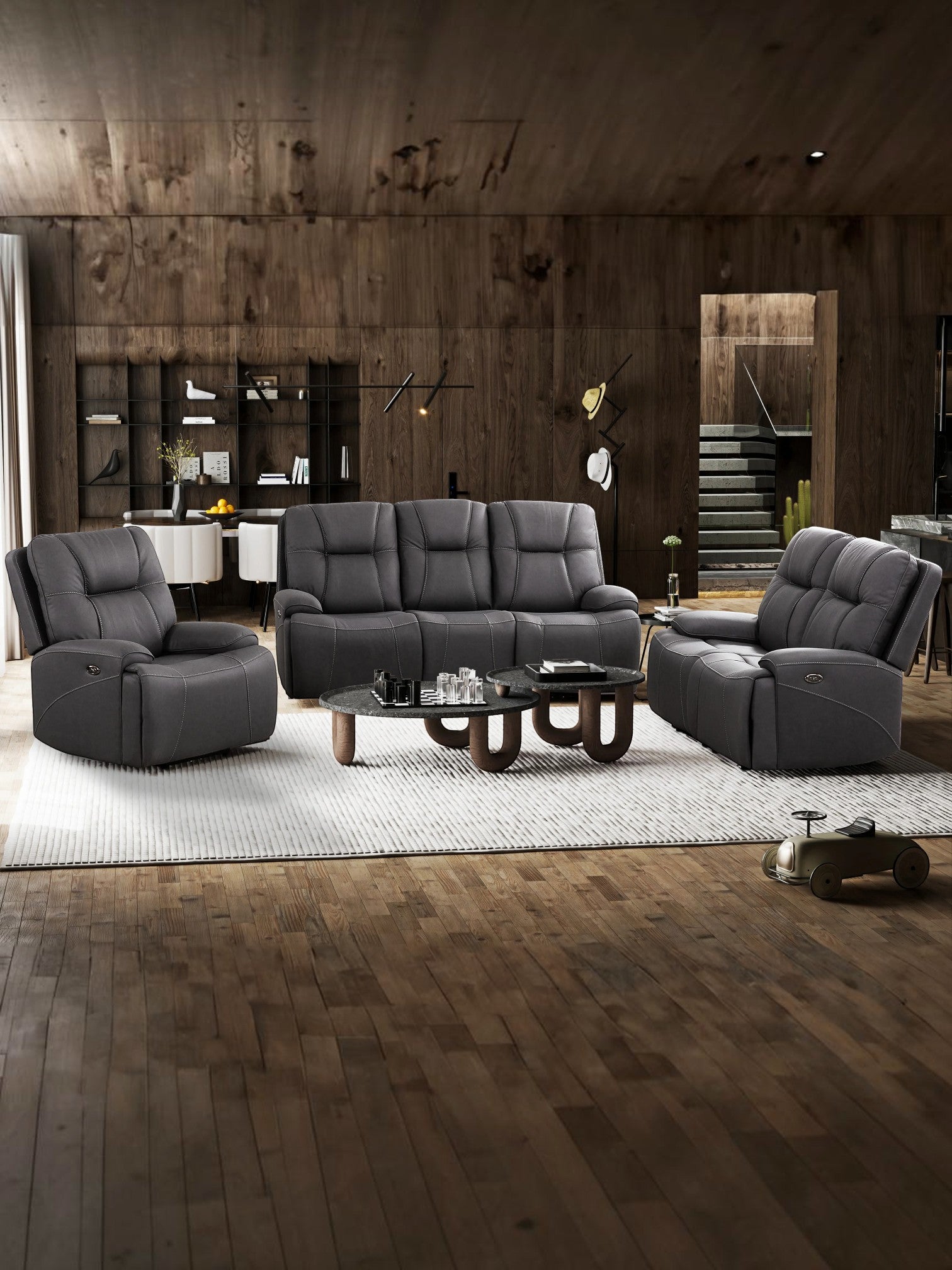 Causeuse inclinable Elvis de TOCO Meubles en cuir gris foncé avec surpiqûres, idéale pour un salon moderne et élégant.