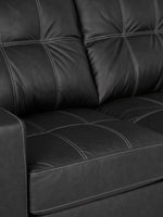 Causeuse TOCO Meubles Marlin en cuir noir avec surpiqûres contrastantes blanches et design capitonné