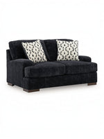 Causeuse Mistral TOCO Meubles en tissu noir texturé avec deux coussins décoratifs à motifs géométriques