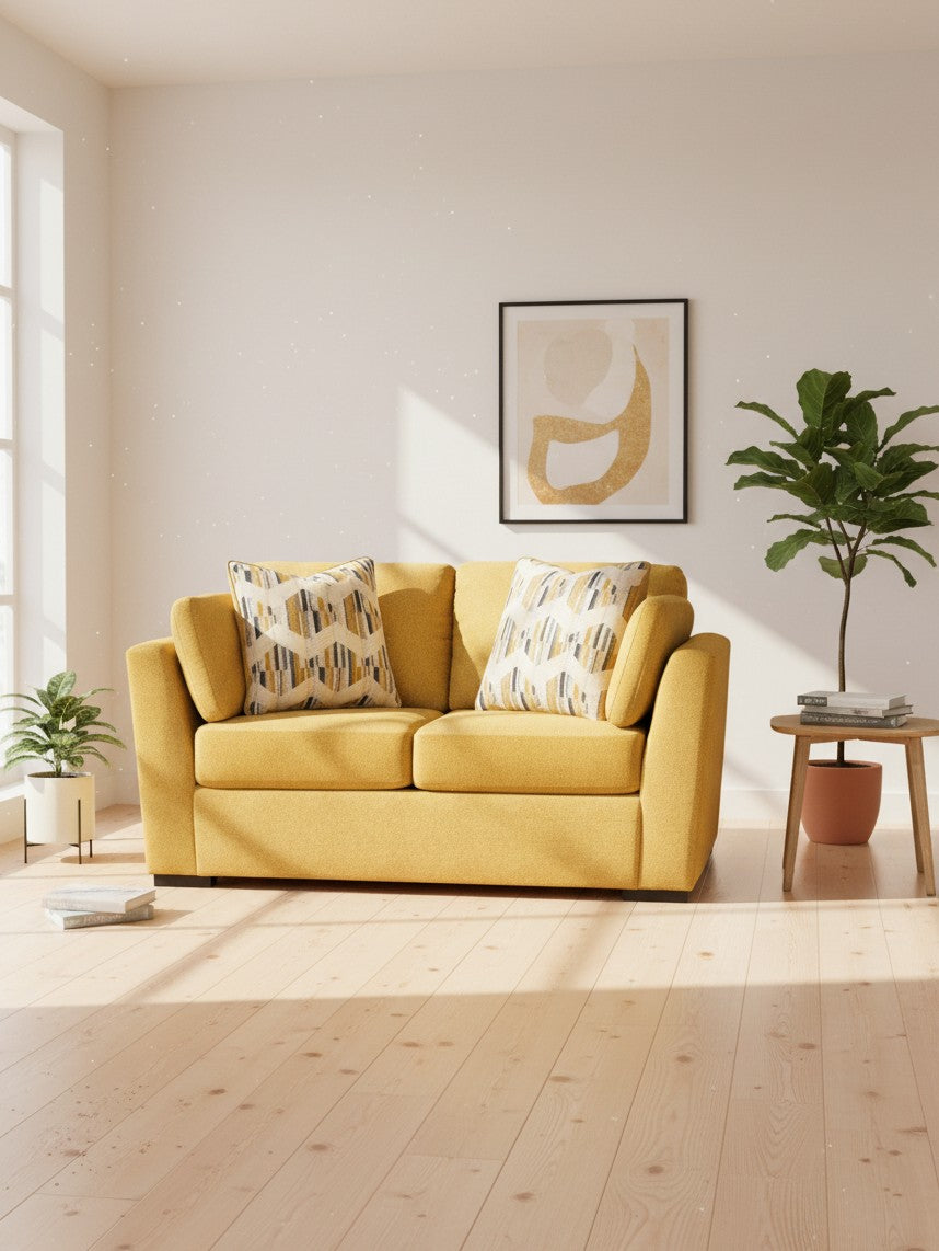 Causeuse TOCO Meubles Owick jaune tournesol avec coussins à motifs dans un salon lumineux et moderne