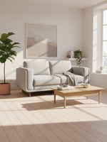 Causeuse Simone grise de TOCO Meubles dans un salon lumineux au style scandinave avec table basse en bois