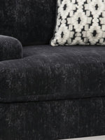 Chaise Mistral TOCO Meubles en tissu texturé noir avec coussin décoratif à motifs géométriques