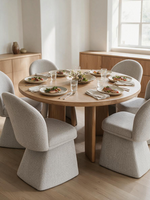 Chaise de salle à manger Noella beige en tissu bouclé par TOCO Meubles autour d'une table ronde en bois clair
