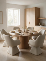 Chaise de salle à manger Capry beige en similicuir avec siège pivotant autour d'une table ronde chez TOCO Meubles