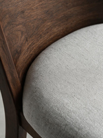 Gros plan sur le dossier en bois brun et le siège rembourré en tissu gris pâle de la chaise TOCO Meubles Tavio