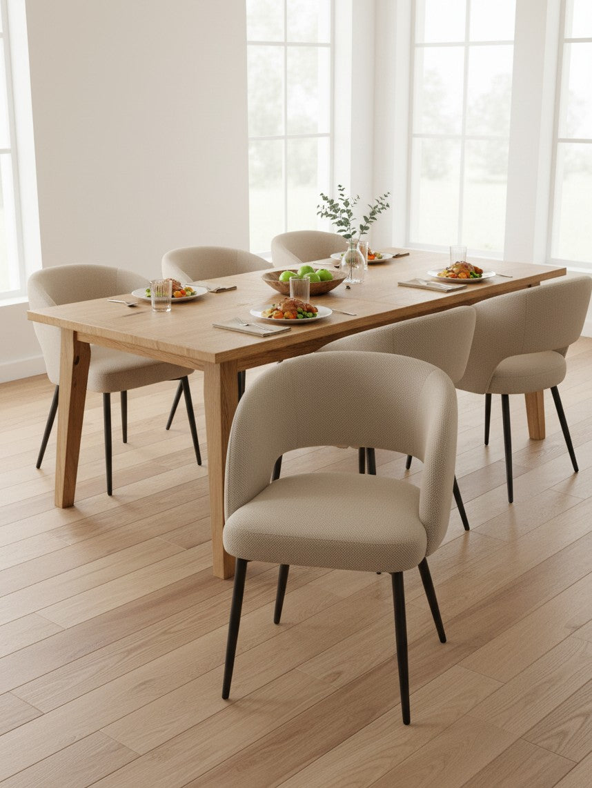 Chaise de salle à manger TOCO Meubles Valmont beige avec dossier incurvé et pieds noirs autour d'une table en bois