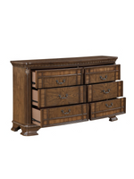 Commode double Émile TOCO Meubles en bois brun foncé avec six tiroirs, moulures sculptées et poignées en bronze.
