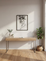 Décoration murale TOCO Meubles en métal noir représentant un portrait féminin stylisé au-dessus d'un bureau en bois.