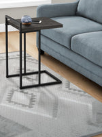TOCO Meubles Eliott C-shaped side table with dark wood-effect top and black metal frame, next to a blue sofa.
