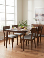 Ensemble de salle à manger Tavio de TOCO Meubles avec table en bois brun et quatre chaises à assise grise rembourrée