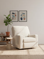 Fauteuil inclinable TOCO Meubles beige en tissu avec jeté, dans un salon moderne avec plante et cadres muraux.