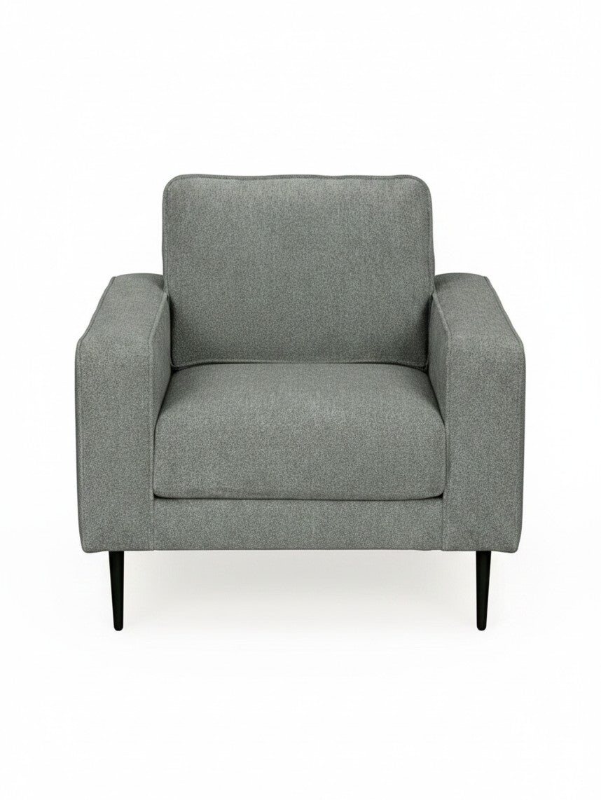 Fauteuil Zela de TOCO Meubles en tissu gris avec accoudoirs larges et pieds noirs fins