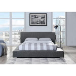 Lit plateforme gris foncé TOCO Meubles Billie avec tête de lit rembourrée, ports USB et rangements intégrés.