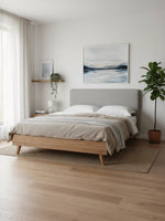 Lit plateforme TOCO Meubles Nova en bois brun avec tête de lit rembourrée grise dans une chambre moderne