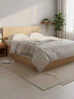 Très grand lit plateforme Hazel par TOCO Meubles en bois naturel au design minimaliste dans une chambre moderne