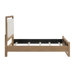 Lit TOCO Meubles Samora en bois brun clair avec tête de lit rembourrée blanche. Design moderne.