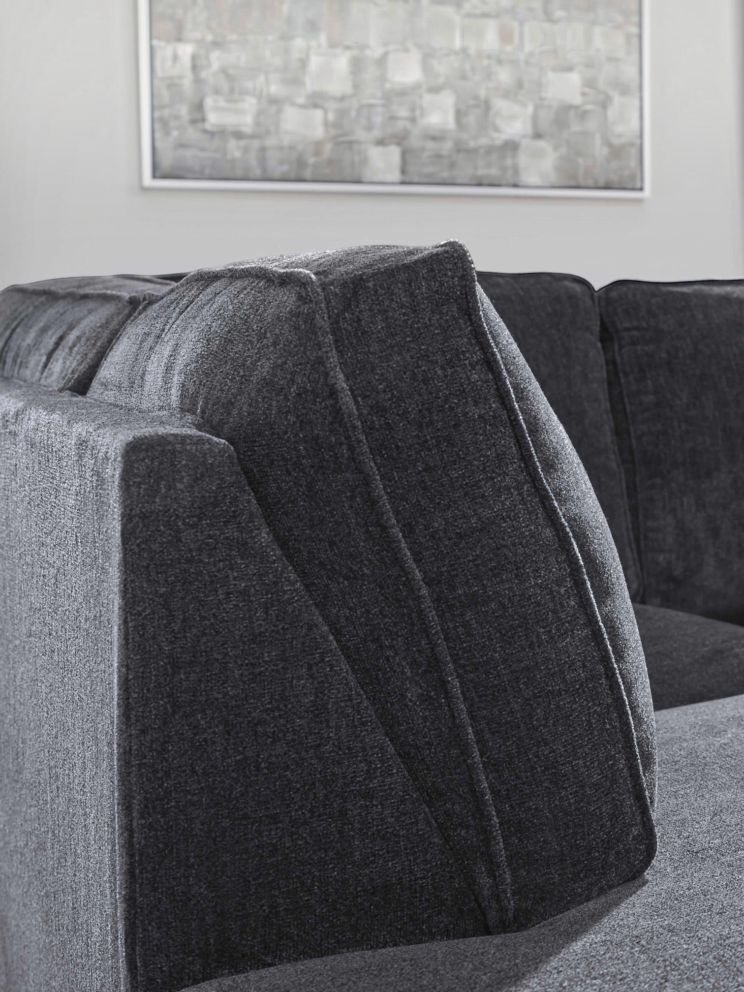 TOCO Meubles Sofa-lit sectionnel Marcel gris foncé en tissu avec coussins texturés et design moderne.