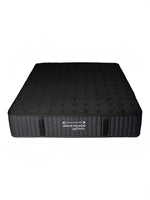 Matelas réversible ferme Dream Shadow Grand de TOCO Meubles avec tissu tricoté noir et capitonnage latéral vertical.