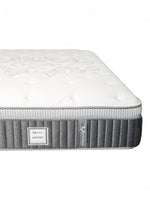 Matelas Optima TOCO Meubles avec tissu matelassé blanc, bordure grise et ressorts ensachés pour un confort optimal.