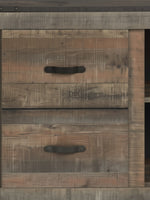 Gros plan sur les tiroirs en bois rustique du meuble télé TOCO Meubles Bastien avec poignées métalliques noires