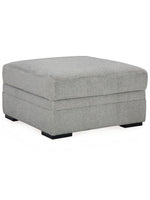 Ottoman Ugo TOCO Meubles carré en tissu texturé gris ciment avec pieds noirs, design moderne et élégant