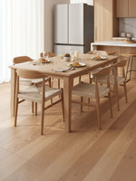 Réfrigérateur MIDEA à portes françaises en acier inoxydable dans une cuisine moderne avec table à manger TOCO Meubles