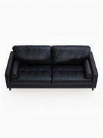 Sofa Bryce de TOCO Meubles en cuir noir avec coussins cylindriques, vue de dessus sur fond blanc