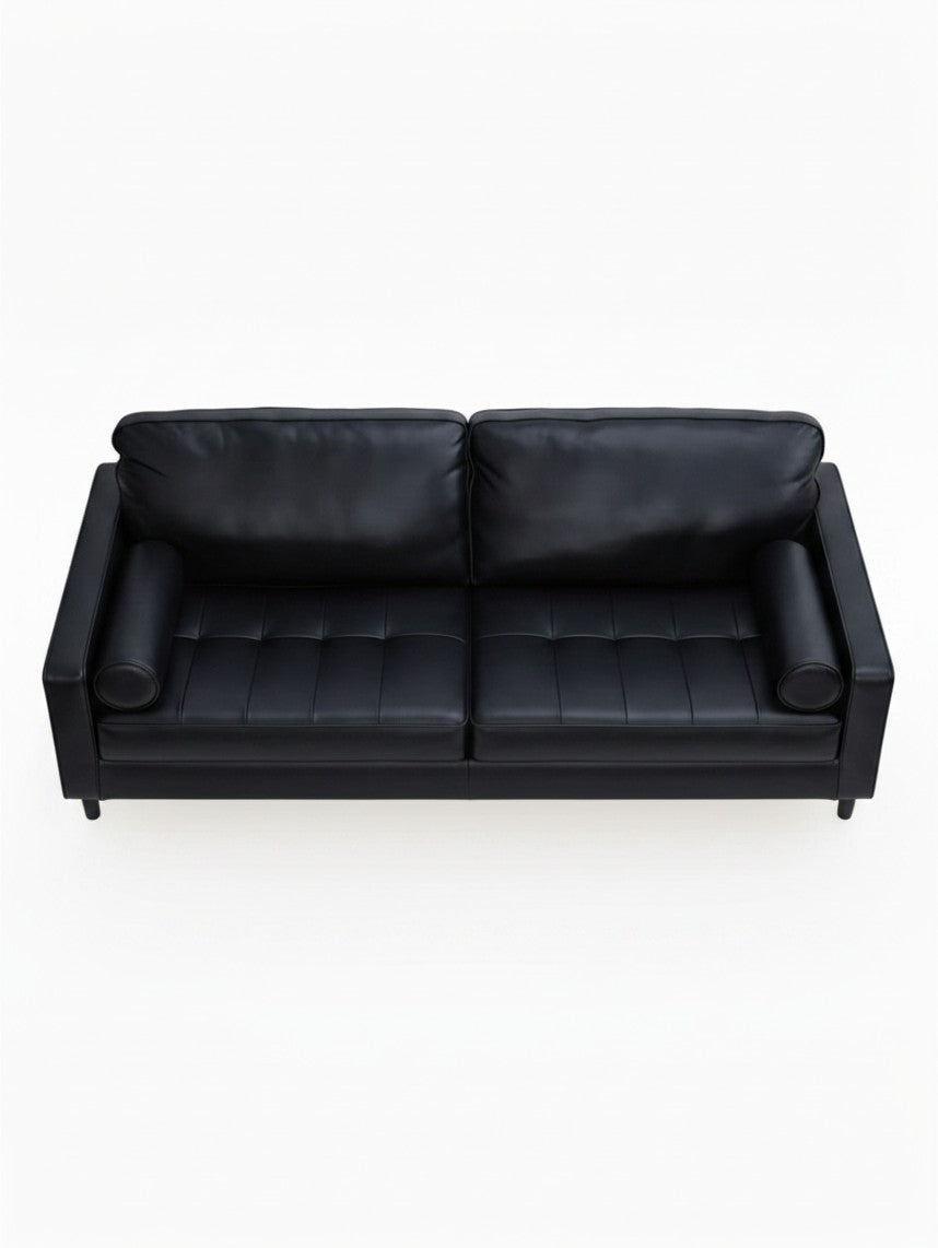 Sofa Bryce de TOCO Meubles en cuir noir avec coussins cylindriques, vue de dessus sur fond blanc