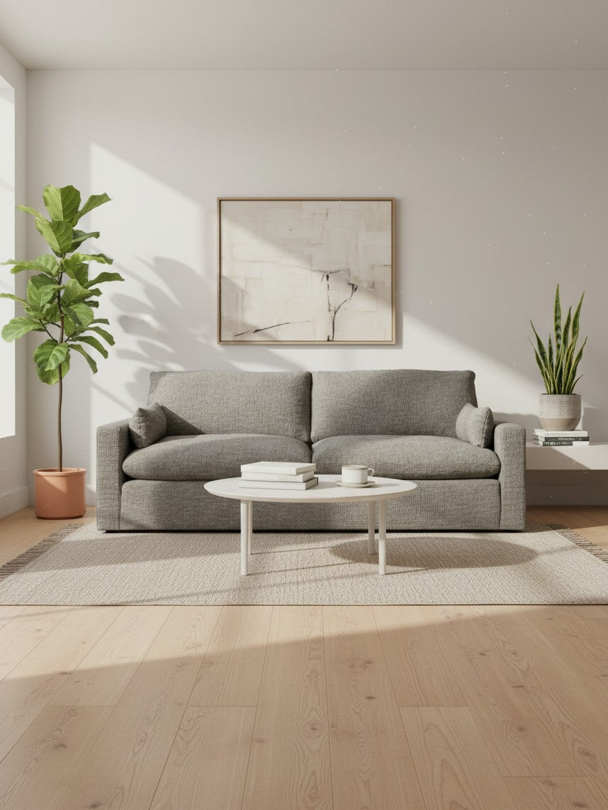 Sofa Faro TOCO Meubles gris en tissu texturé dans un salon moderne avec plante et table basse blanche