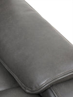 Gros plan sur le revêtement en cuir gris foncé texturé de l'accoudoir du sofa inclinable Lewis de TOCO Meubles