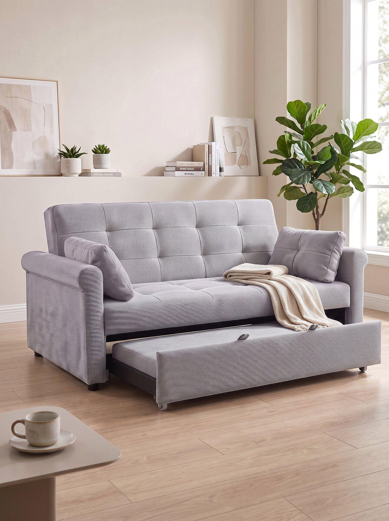 Sofa-lit Thomas de TOCO Meubles en tissu gris texturé avec tiroir gigogne et coussins assortis dans un salon moderne