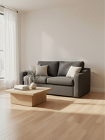 Sofa-lit Ayana de TOCO Meubles gris foncé convertible dans un salon lumineux avec table basse en bois clair