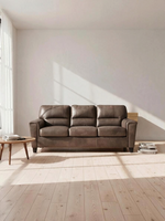 Sofa-lit convertible Kairo de TOCO Meubles en aspect cuir marron dans un salon lumineux au style scandinave
