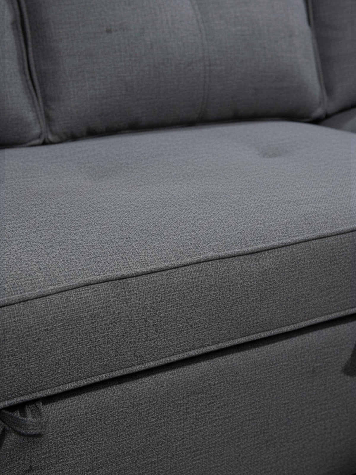 Sofa-lit Kendi de TOCO Meubles en tissu gris texturé avec des coussins confortables pour un salon contemporain.